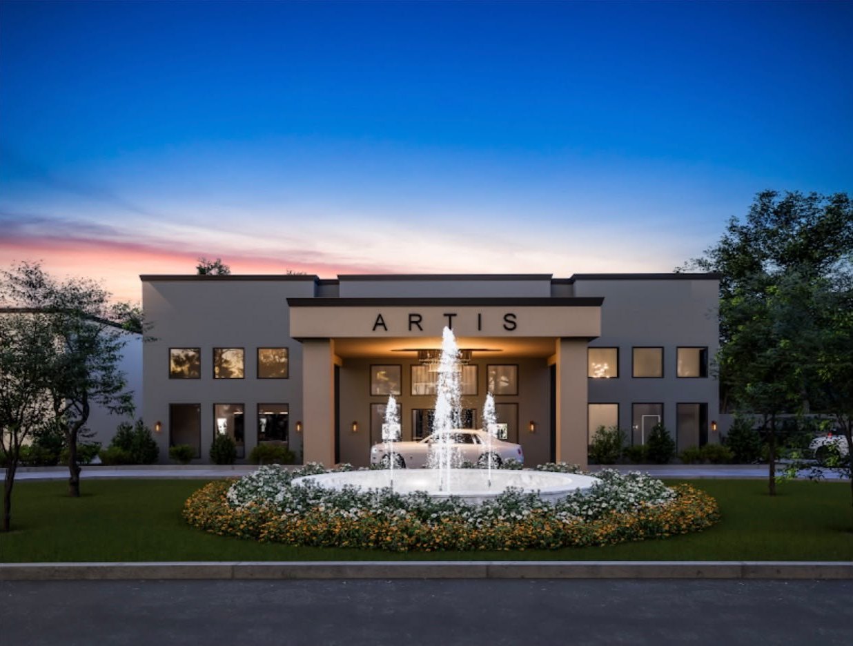 Artis Event Center at dusk, with its lit fountain