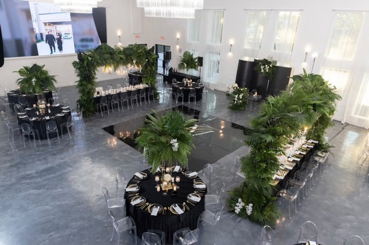 The Artis reception hall set in black and gold with tropical greenery